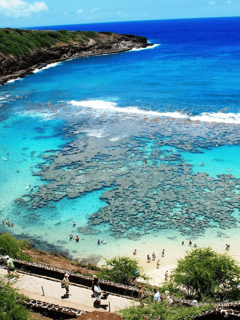 Breathtaking coastal scenery featuring clear turquoise waters and rocky tide pools at a popular beach destination.