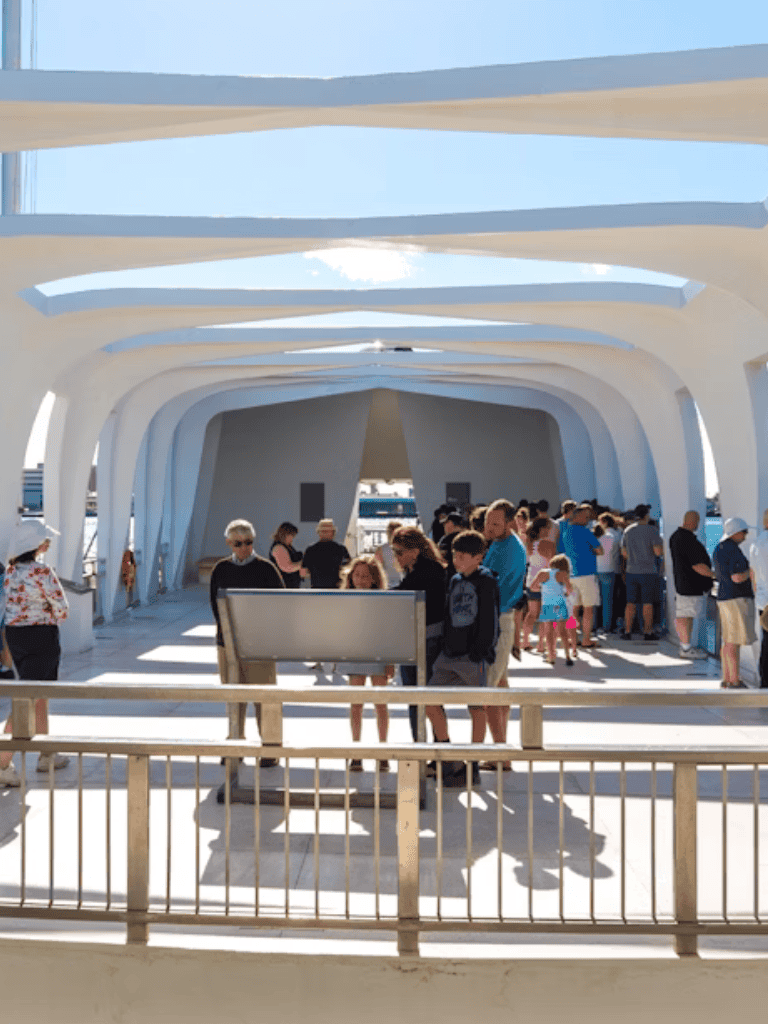 Modern ferry terminal with people waiting, architectural design, and coastal views.