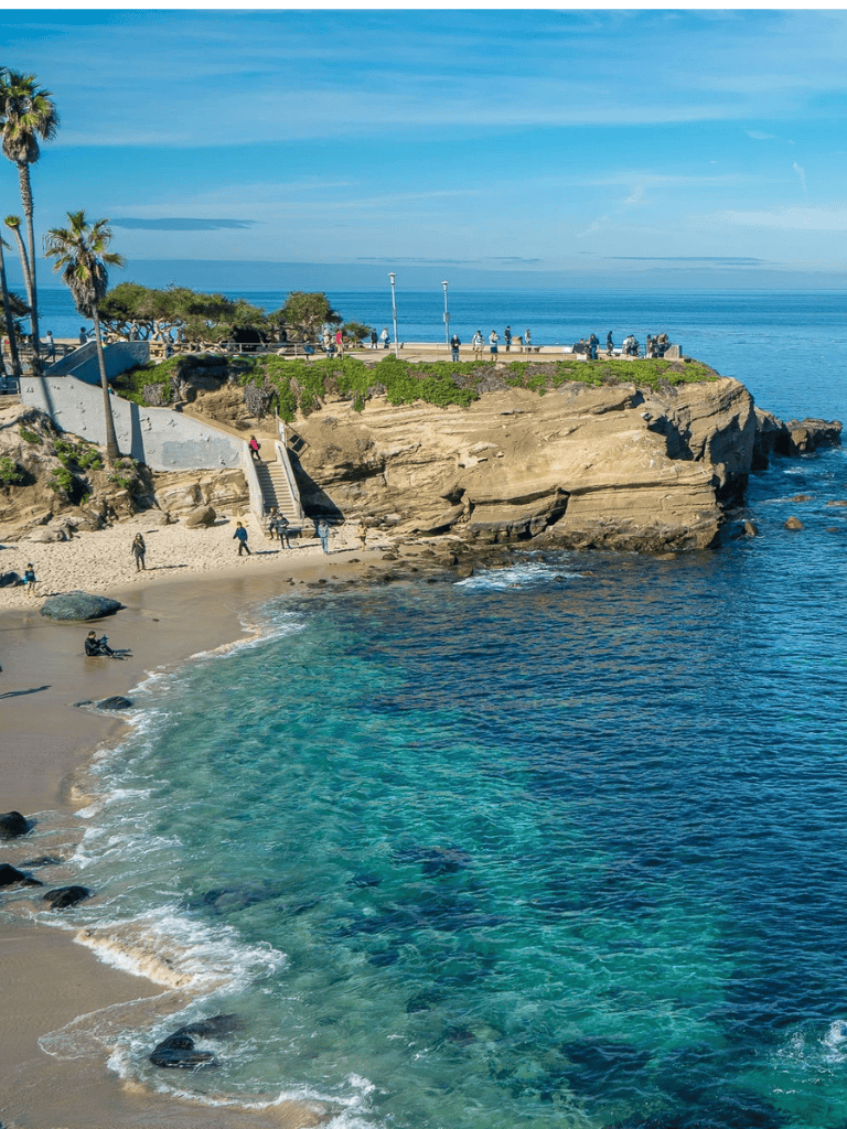 Scenic coastal view at sunset with beach, cliffs, and ocean in San Diego.