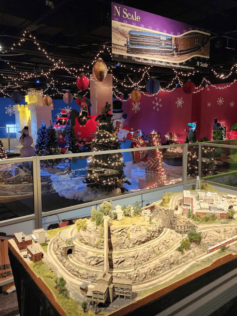 Christmas train display with festive decorations and Santa themed elements at QuestForDirections.