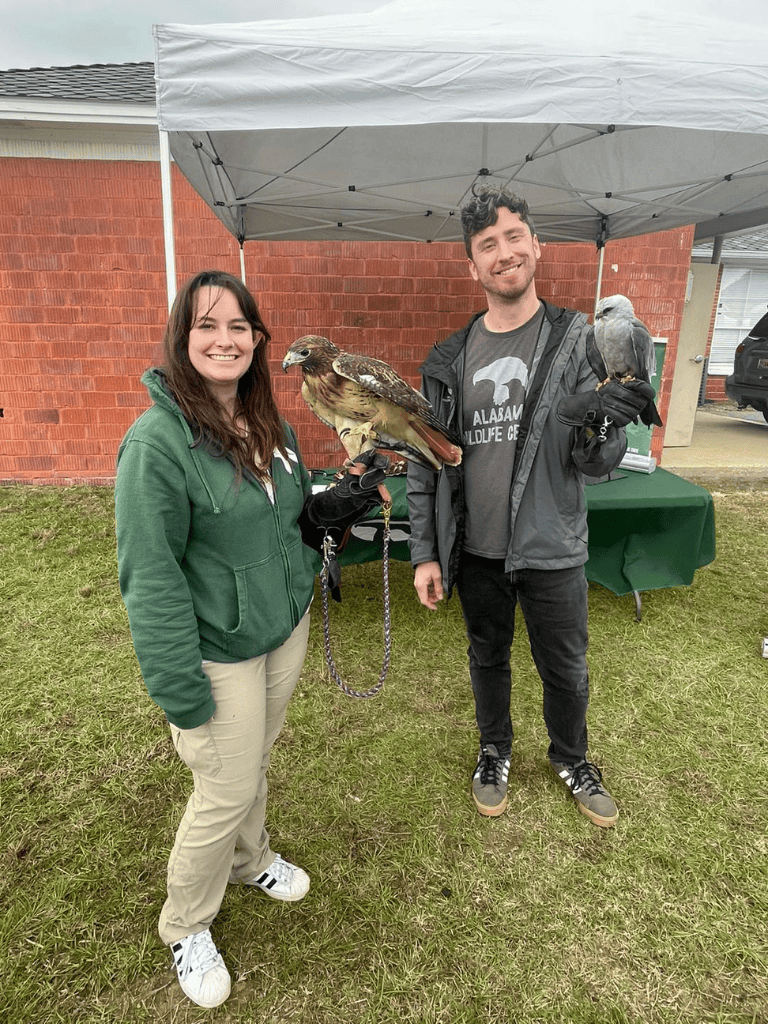 1. People holding falcons outdoors at Quest for Directions event.