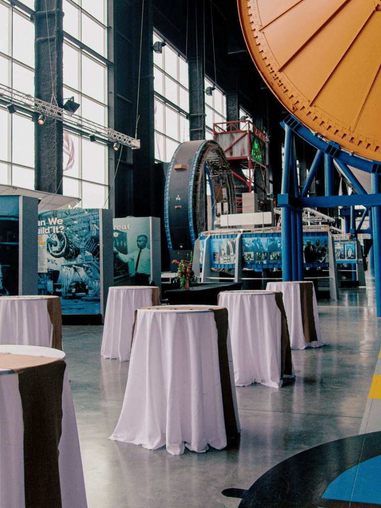 Engine of a spacecraft with tables for presentations inside a space museum or science center.
