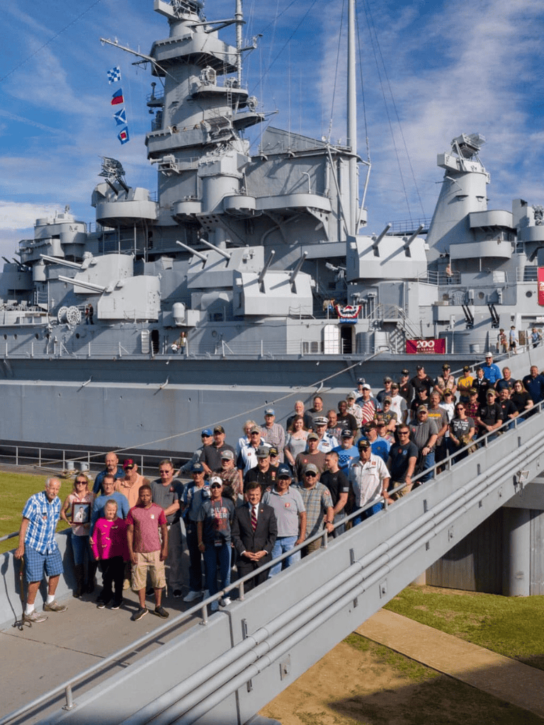 Guided tour of battleship USS Missouri with group of visitors and crew members.