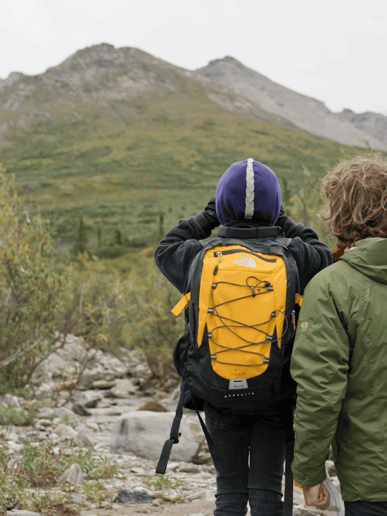 Exploring nature with backpackers on a mountain trail for outdoor adventure and navigation.