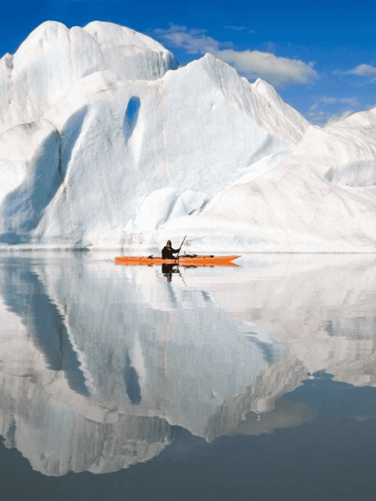 Glacier kayak adventure in icy waters with towering icebergs and stunning reflection scenery.