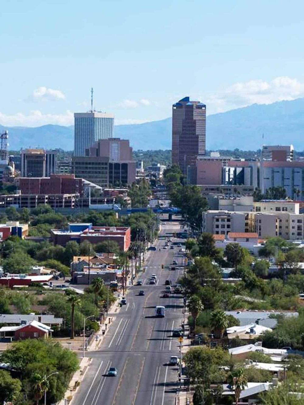 Vibrant cityscape of Boise, Idaho with downtown skyscrapers and scenic mountain background.