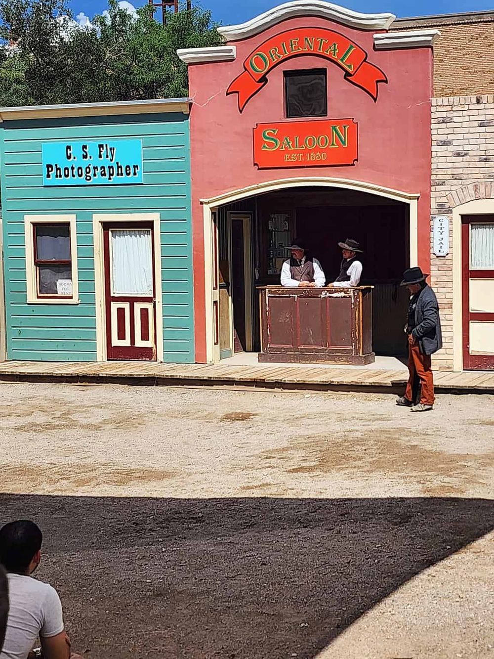Authentic Wild West scene with vintage buildings and costumed actors representing an Old West setting.