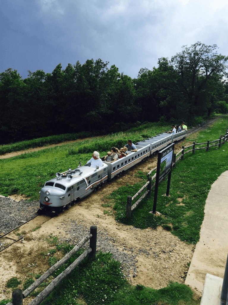 Vintage train ride through scenic outdoor park, ideal for family outings and adventure.