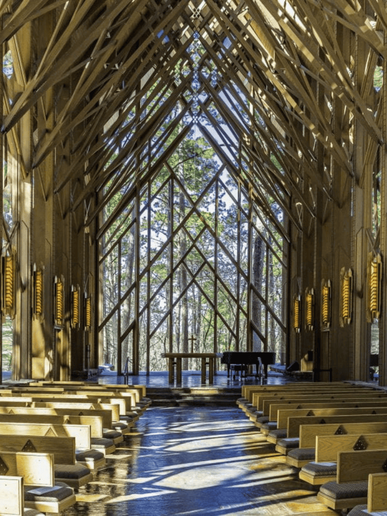 Natural wood church interior with modern design and large glass windows for spiritual reflection.