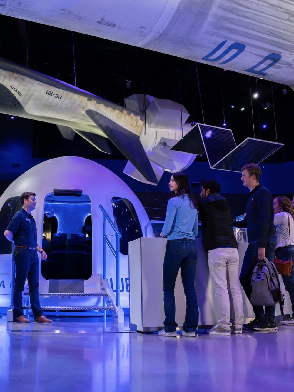 Aerospace technology exhibit with visitors exploring virtual flight experience and space-themed displays for travel inspiration.