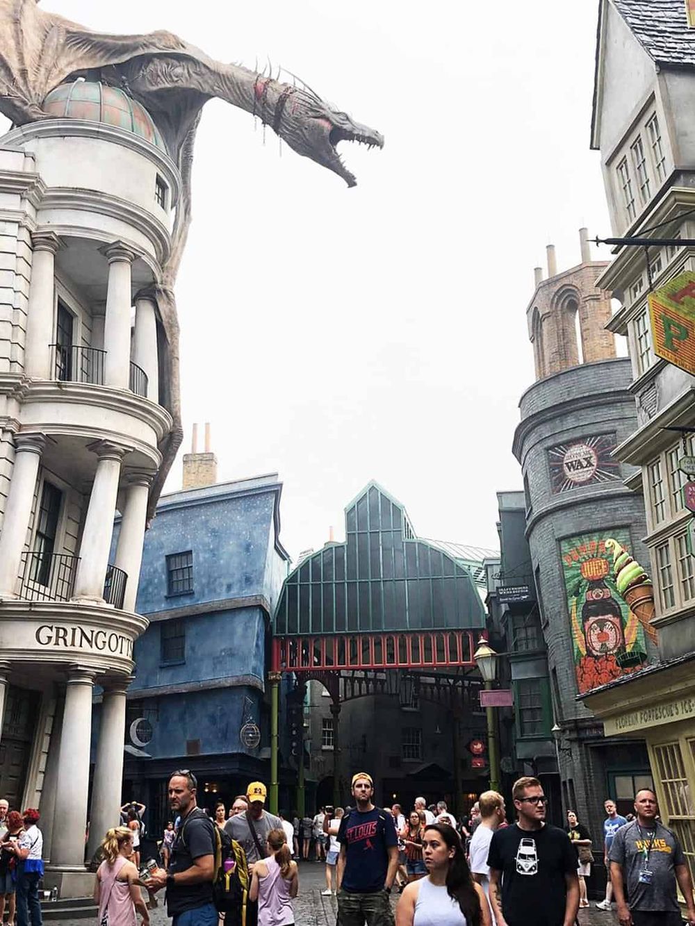 Large dragon prop in Harry Potter-themed streetscape at Universal Studios.