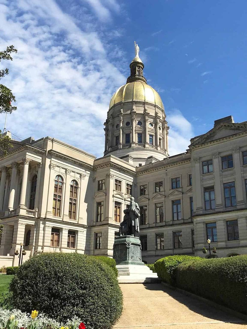 Historic government building with a golden dome and classic architecture, perfect for city tour information.