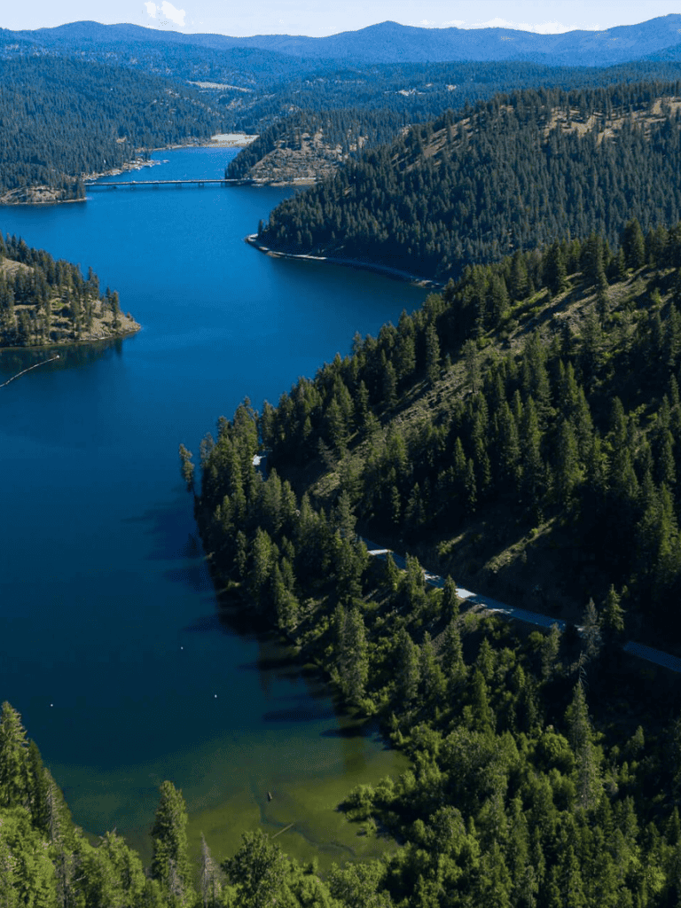Peaceful mountain lake surrounded by evergreen trees and scenic landscape at QuestForDirections.