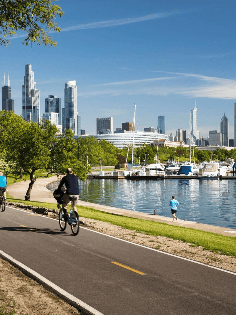 Scenic Los Angeles waterfront with cyclists and city skyline in the background.