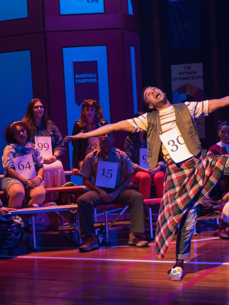 Imaginative theatrical performance with vibrant lighting and diverse cast, highlighting creativity and entertainment.