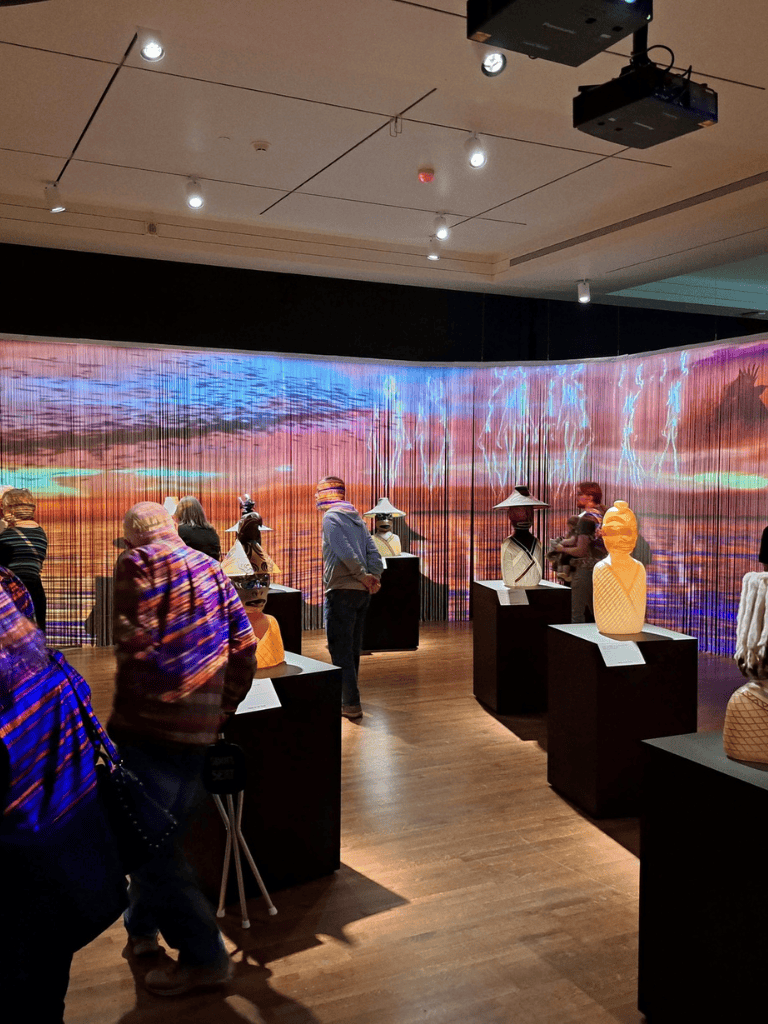 Colorful art exhibit showcasing sculptures and digital landscape at QuestForDirections museum.