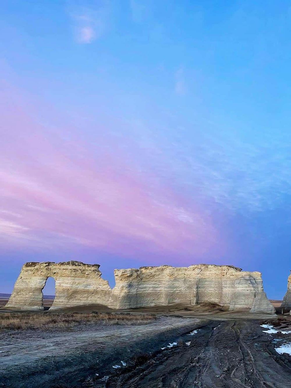 Dramatic rock formations in a desert landscape at sunset, highlighting adventure and travel destinations.