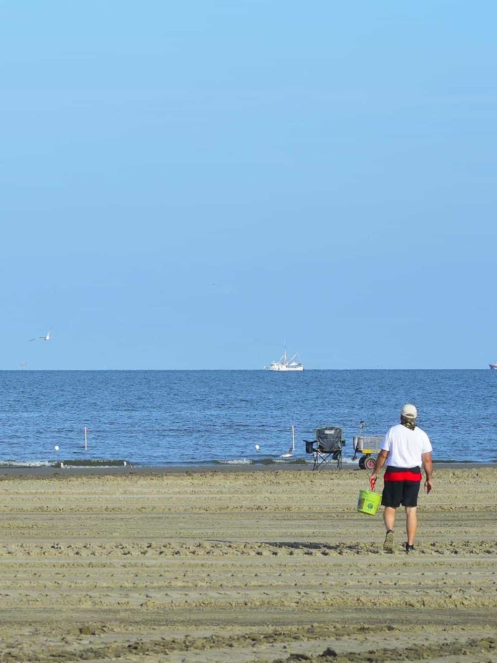 Seaside fishing with a boat, ocean, and beach scenery, representing quest for directions.