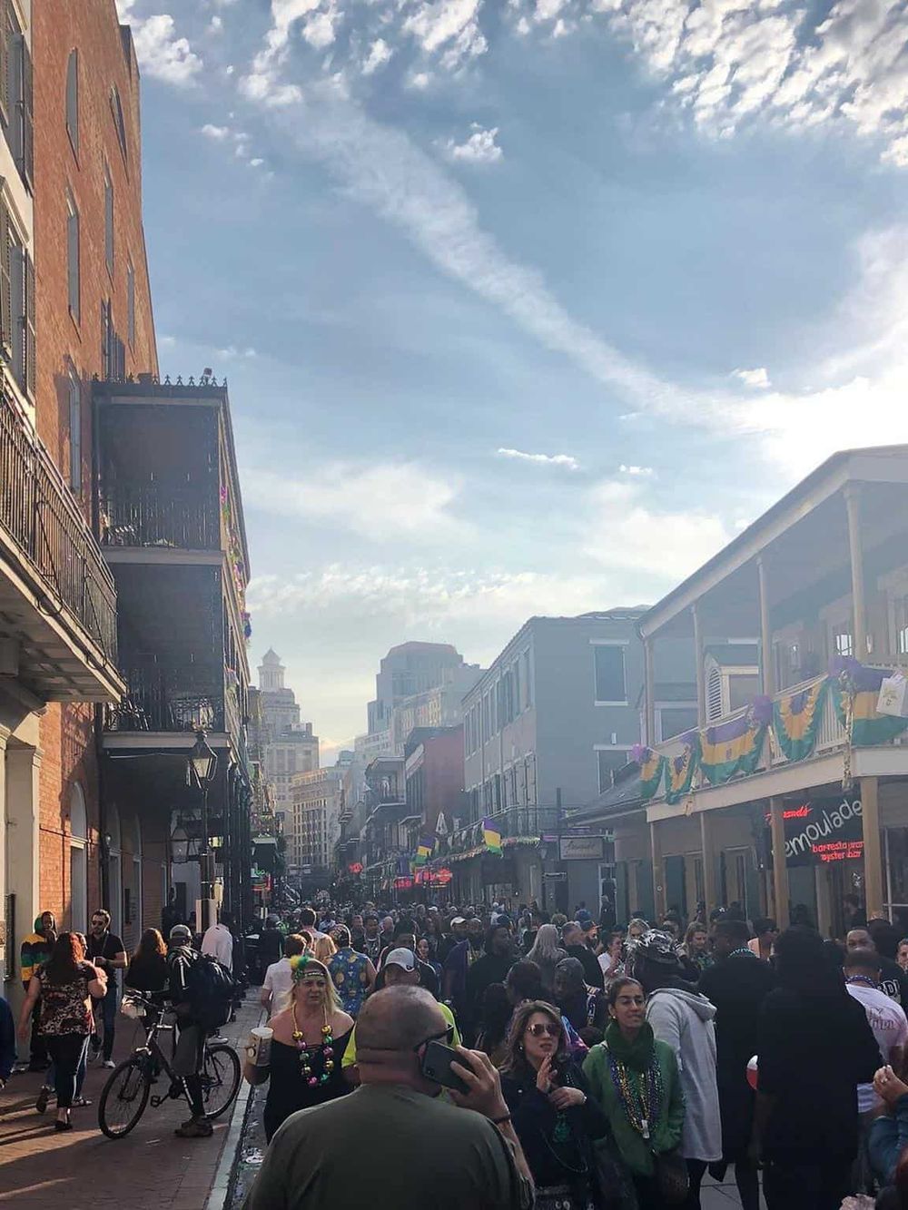 Crowded street during Pride celebration with festive decorations in San Francisco.
