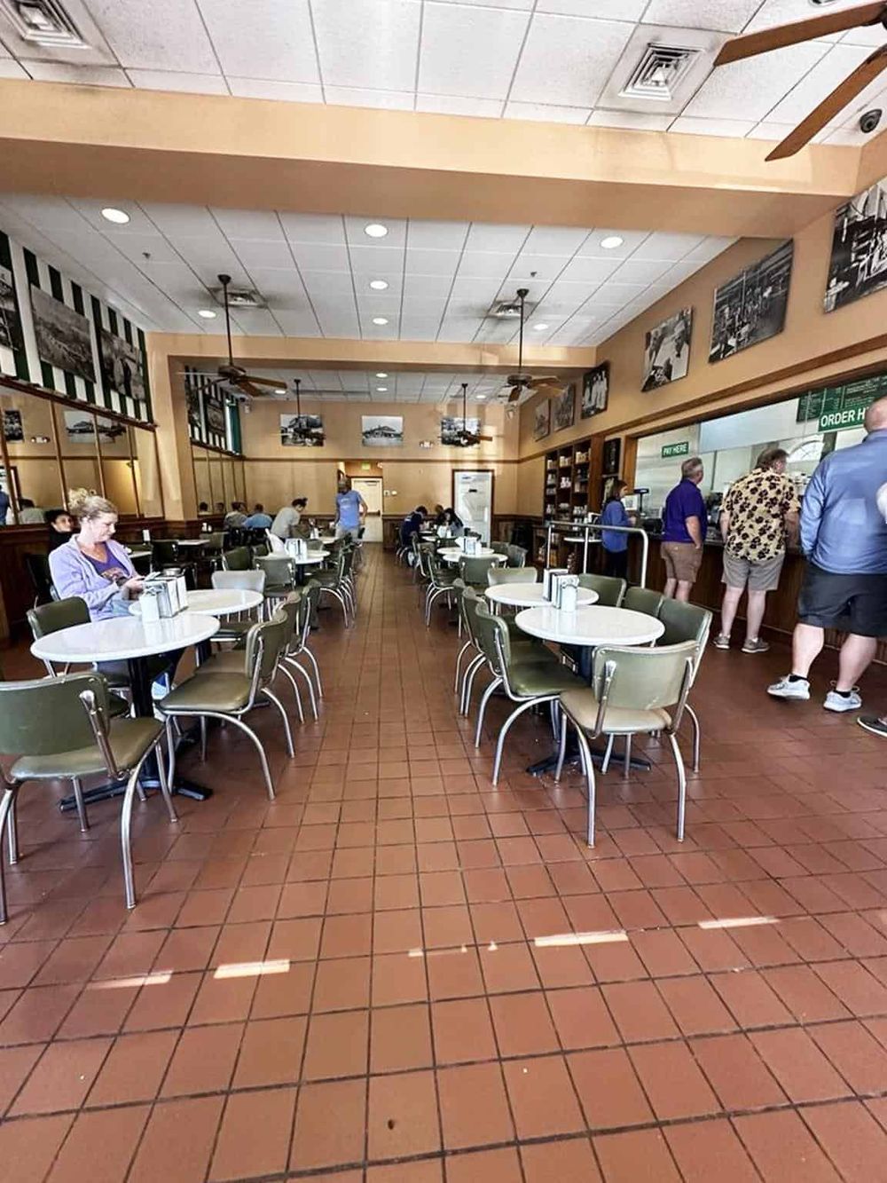 Bright, family-friendly restaurant interior with seating, order counter, and diners at Quest for Directions.