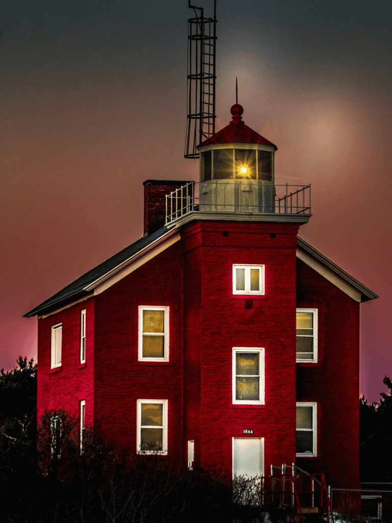 Red lighthouse building at sunset, iconic coastal navigation landmark, QuestForDirections.