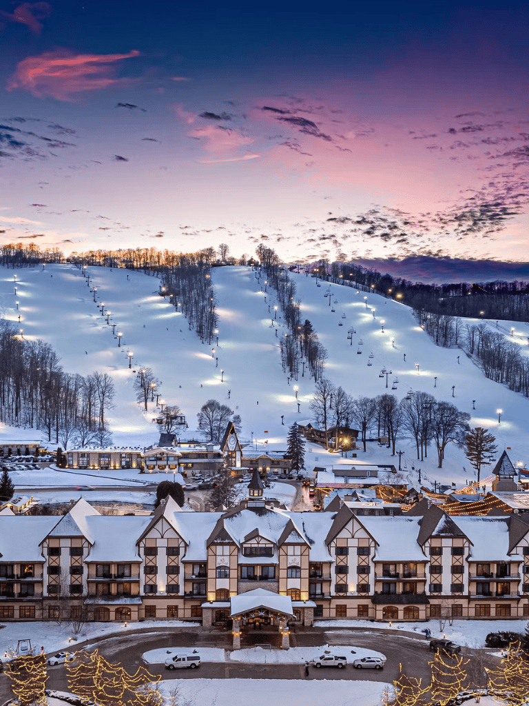 Snowy mountain resort with ski slopes at sunset at QuestForDirections.