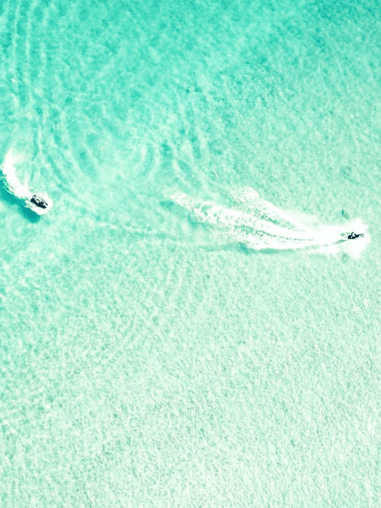 Spectacular aerial view of boats sailing on turquoise ocean waters, ideal for travel and adventure SEO keywords.