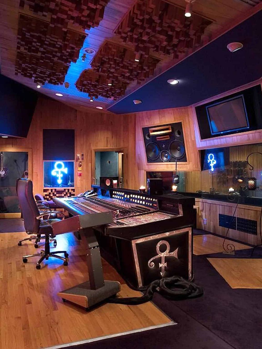 Elegant recording studio control room with digital mixing console and acoustic treatment.
