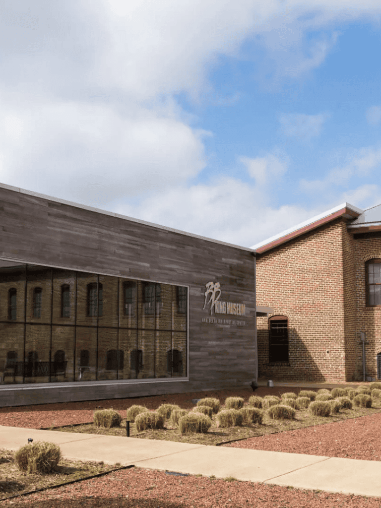 Modern museum building with brick and wood exterior, showcasing historical exhibits and innovative research facilities.