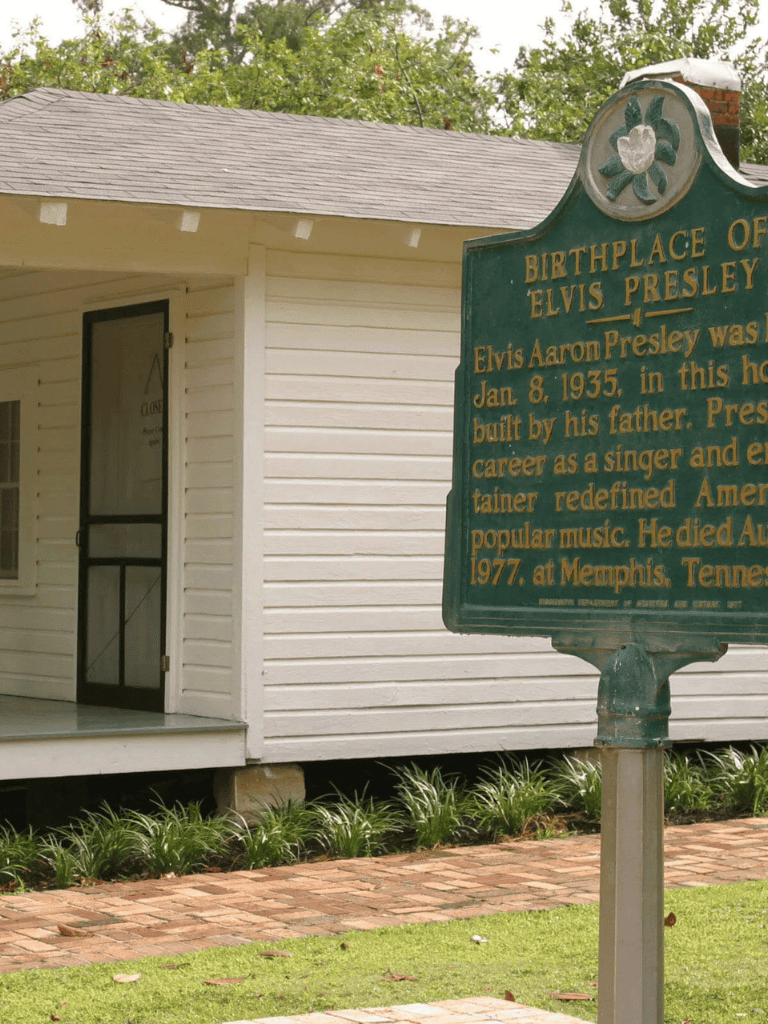 Elvis Presley birthplace historic site in Memphis Tennessee, featuring a marker and a house.