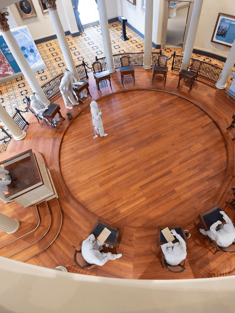 Elegant historical museum interior with wax figures and polished wooden floors, perfect for educational tours.