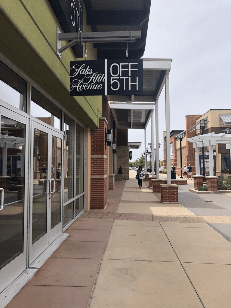 Qualifying Alt Text: Saks Fifth Avenue store off 5th shopping outlet, outdoor shopping mall, storefront.