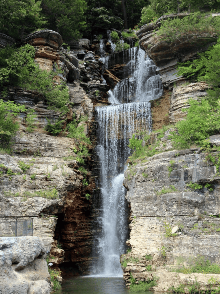 Cascade waterfall in lush green forest, scenic natural sightseeing spot.