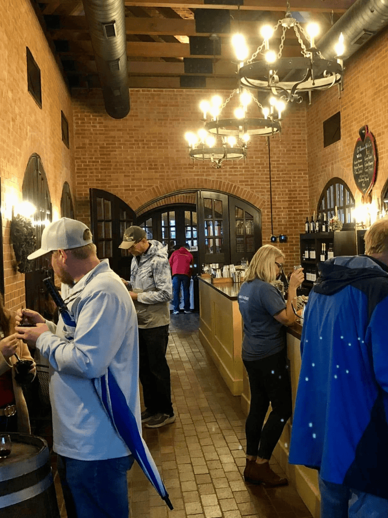 Quiet indoor scene at QuestForDirections wine bar with customers enjoying drinks and socializing.