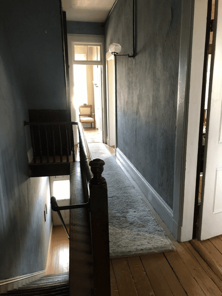 Ndoor hallways and staircase of a cozy home, bright natural light, classic interior decor.