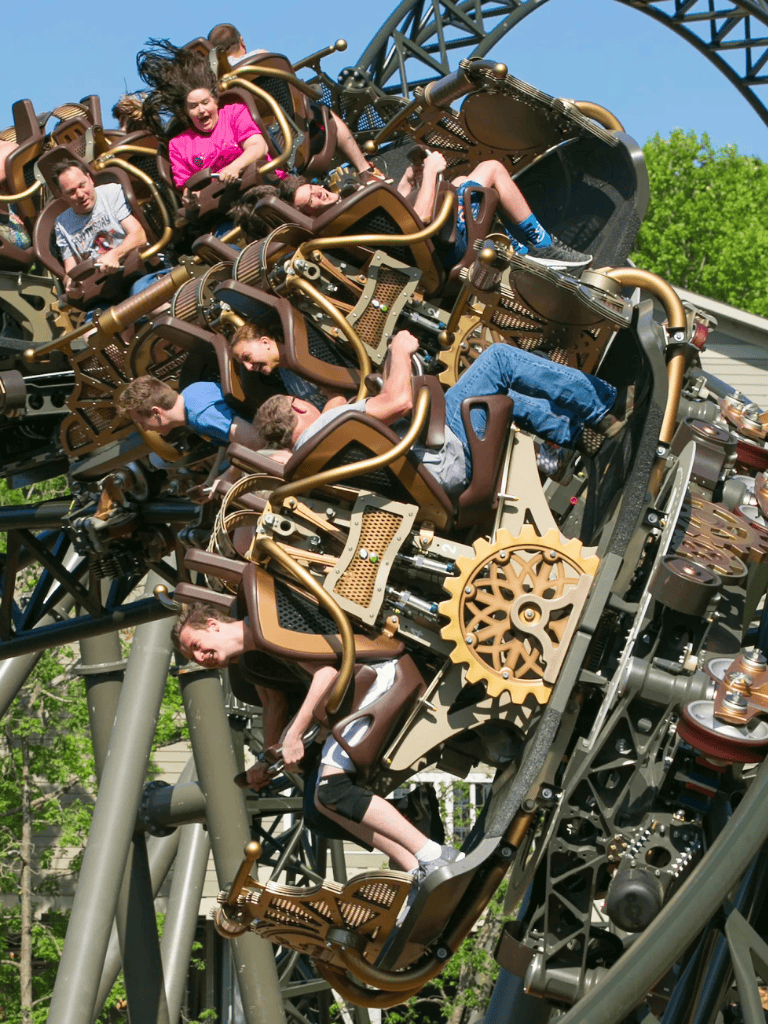 Thrilling roller coaster ride at QuestForDirections amusement park with excited children.