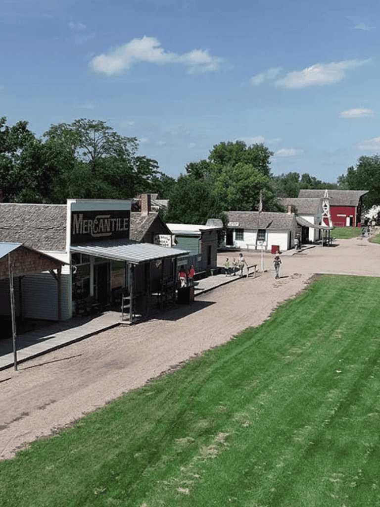 Vintage Americana town with historic shops and scenic greenery at Quest for Directions.