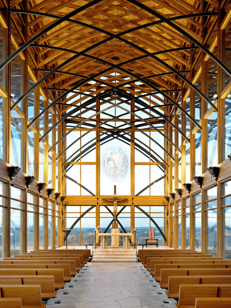 Stunning modern church interior with wooden architecture and large windows for natural light.