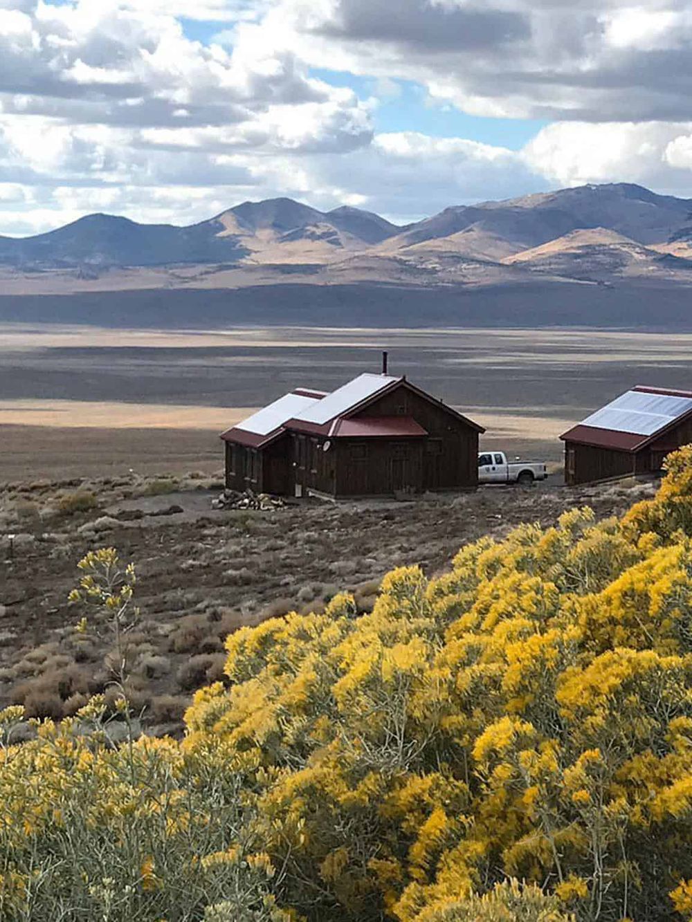 Remote mountain cabin in vast open landscape, iconic for adventure and outdoor exploration.