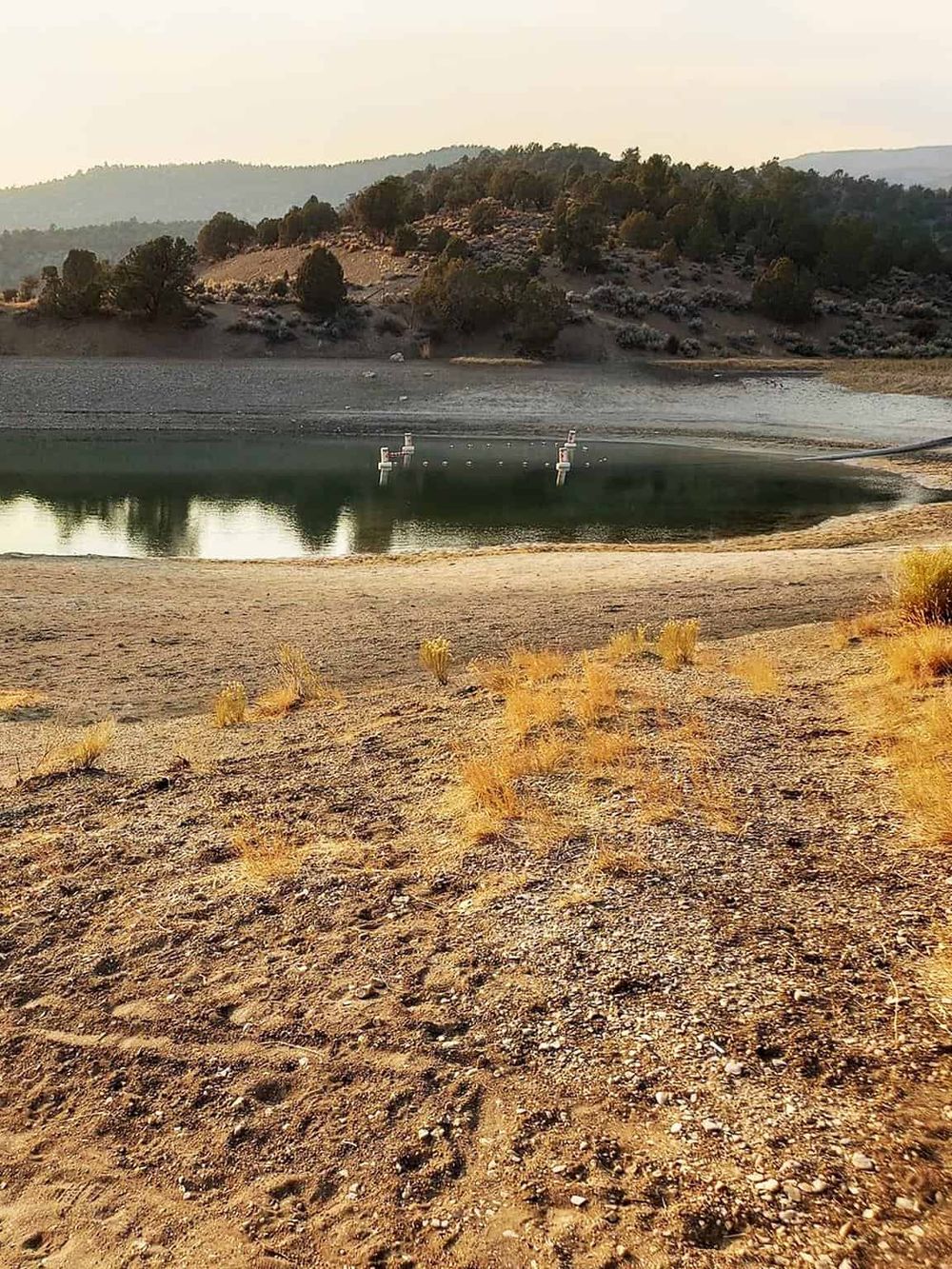 Serene desert reservoir surrounded by mountains, perfect for outdoor adventures and scenic exploration.