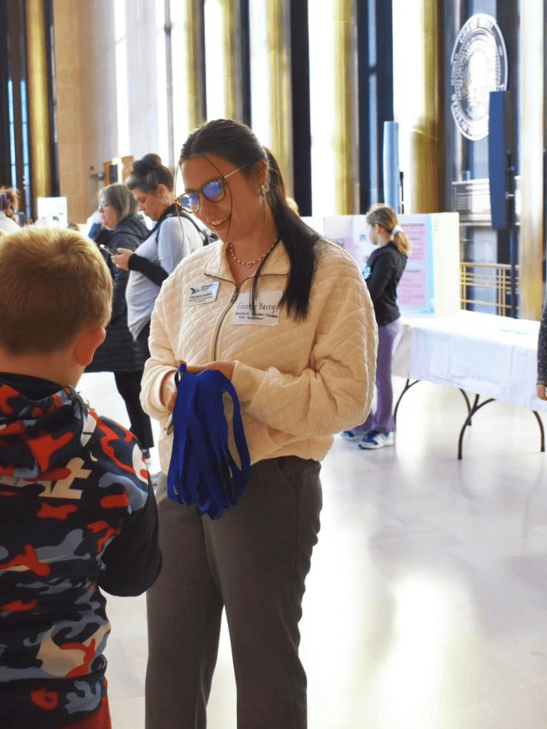 Friendly event staff handing out materials at QuestForDirections event, engaging with attendees for navigation solutions.