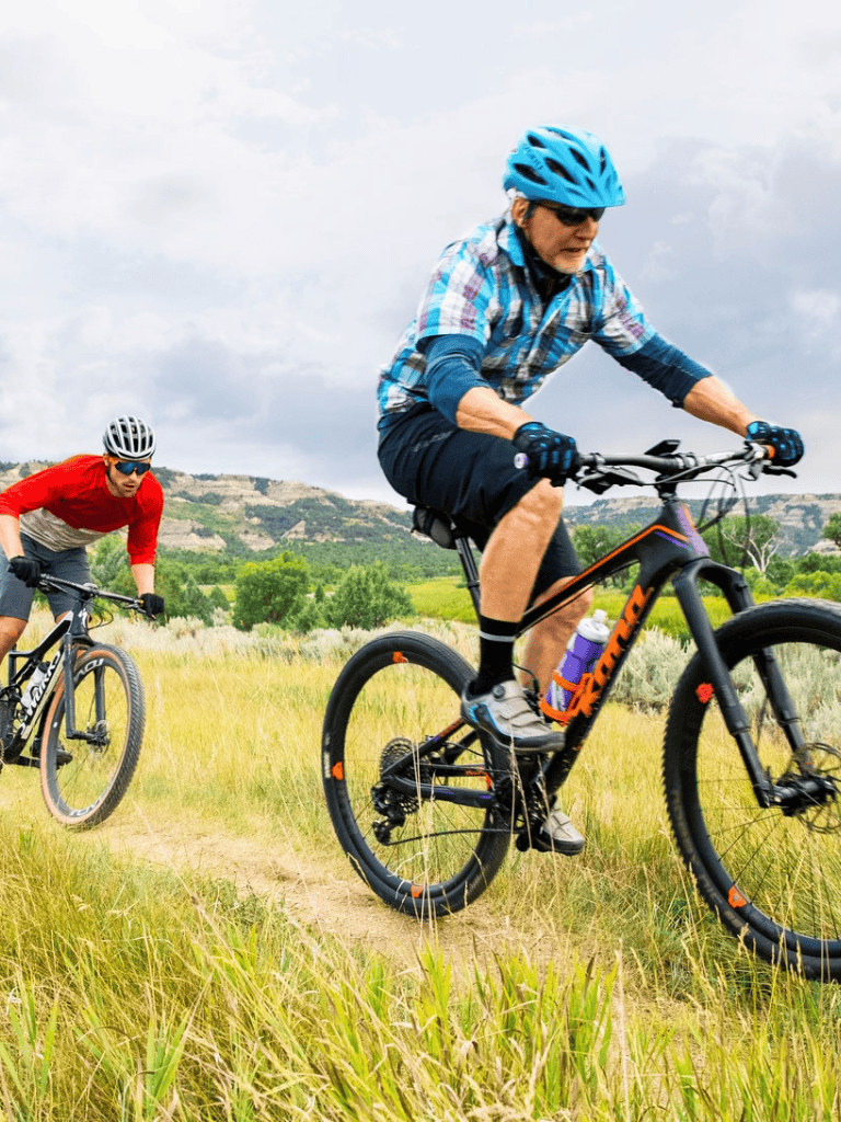 Enjoying outdoor mountain biking adventure in scenic landscape for fitness and recreation.