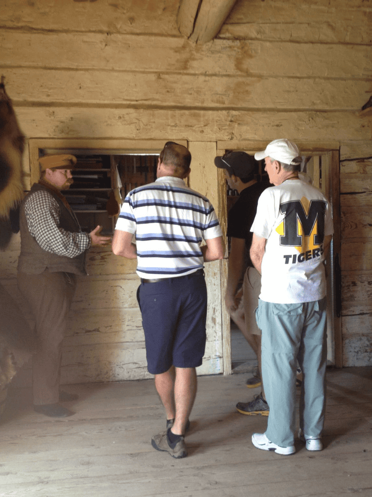 Genuine guided tour inside historic wooden cabin, exploring early American life and architecture.