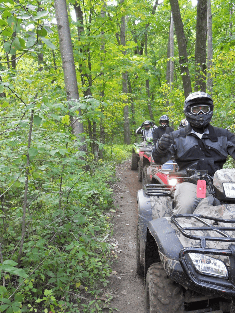 ATV riding adventure in lush green forest trails.
