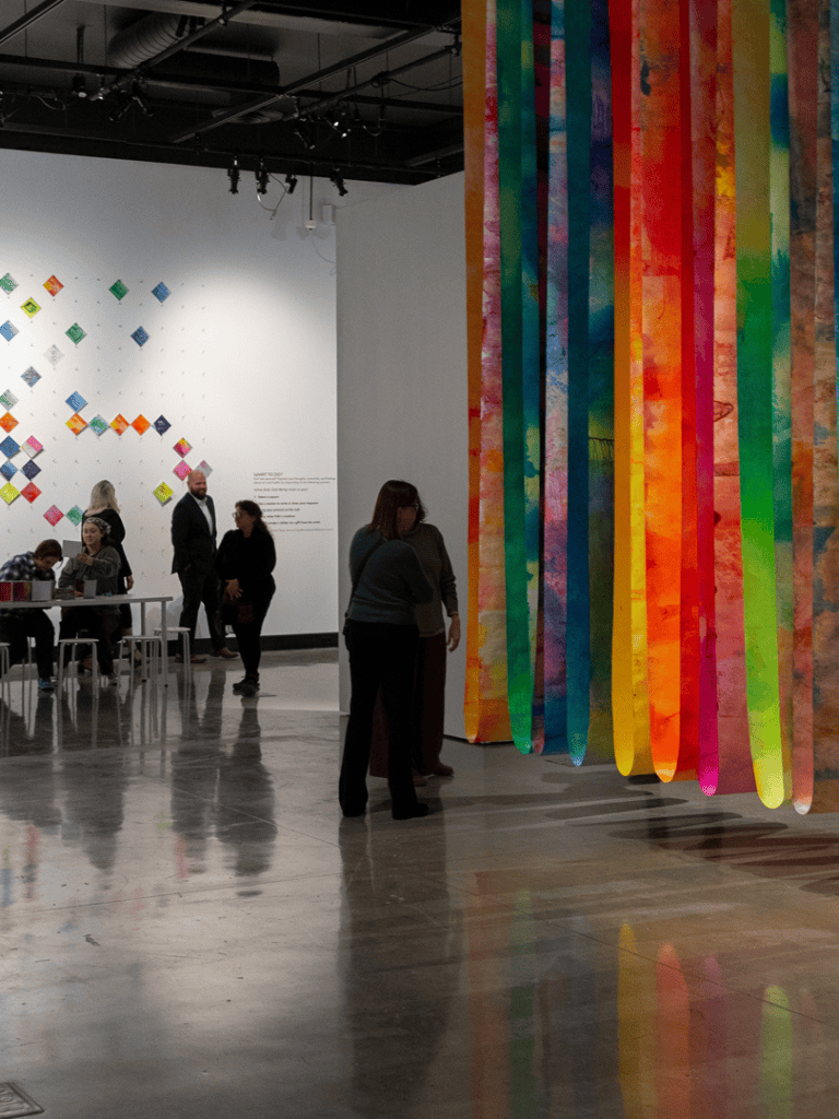 Colorful art installation at QuestForDirections exhibit in a modern gallery space.