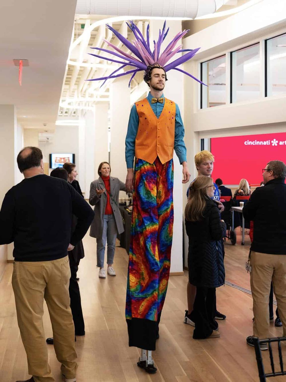 Colorful performer on stilts at Cincinnati Arts Center, vibrant costume, creative entertainment, event, arts and culture celebration.