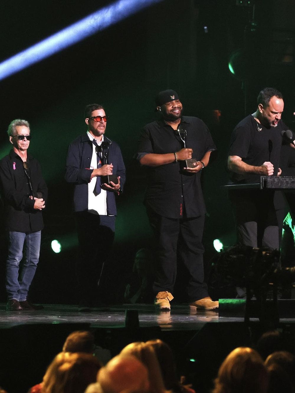 Celebrating success at a music awards event with diverse artists on stage, showcasing talent and achievement.