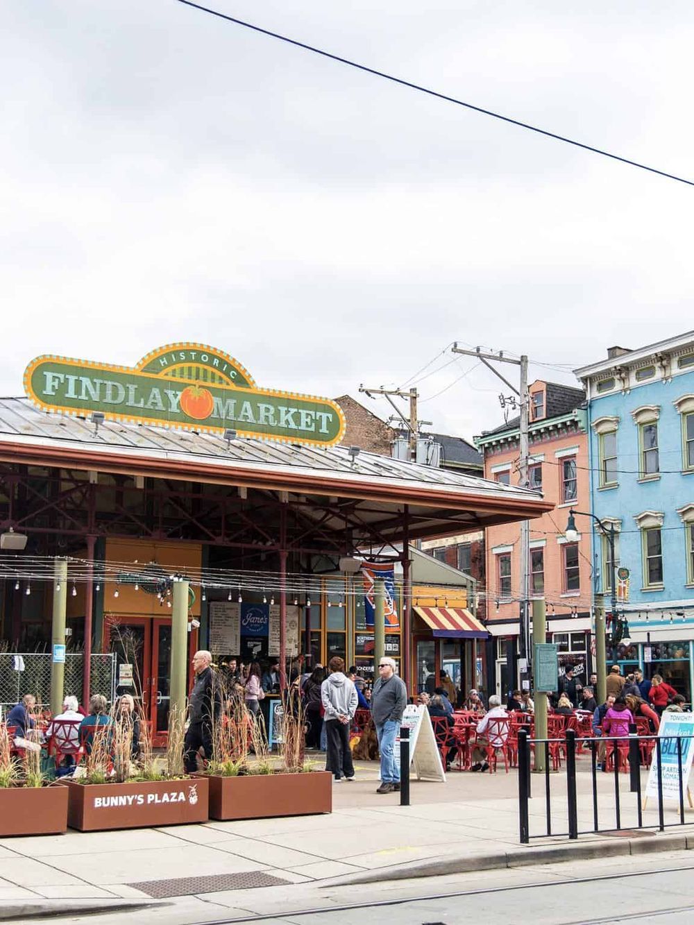 Historic Findlay Market in Cincinnati, Ohio, bustling with visitors and vibrant cityscape.