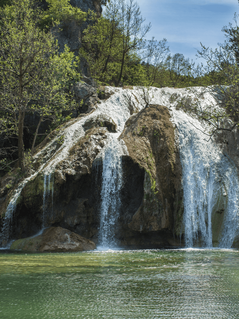Serene waterfall at Quest for Directions scenic outdoor location, lush greenery and natural beauty.