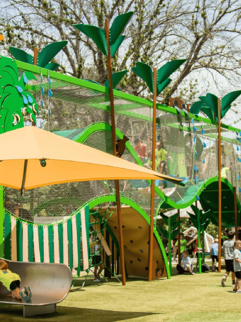 Colorful outdoor kids' playground with climbing structures and slides, ideal for family fun and recreation.